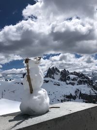 Snow covered sculpture against sky