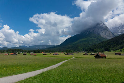 Scenic view of field and mountains against sky