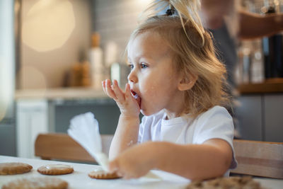 Portrait of cute girl sitting on table