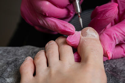 Cropped hand of man holding syringe