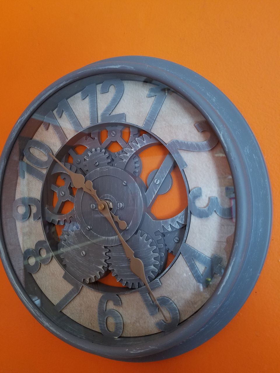 DIRECTLY ABOVE SHOT OF CLOCK AND ORANGE ON WALL