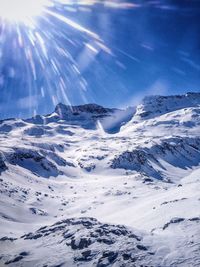 Scenic view of snow covered mountains against sky