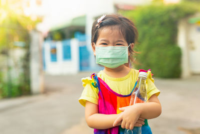 Portrait of boy standing outdoors