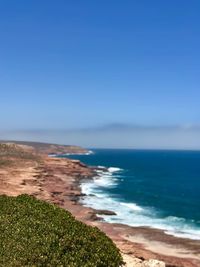 Scenic view of sea against clear blue sky