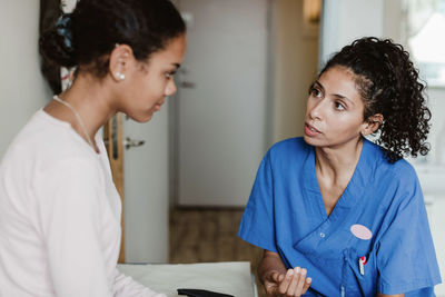 Female doctor discussing with patient in medical room at hospital