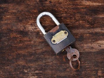 Close-up of padlock on rusty metal