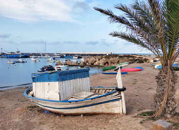 Boats moored on sea against sky