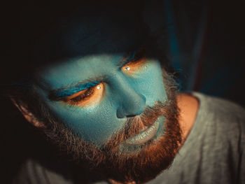 Close-up of serious man with painted face