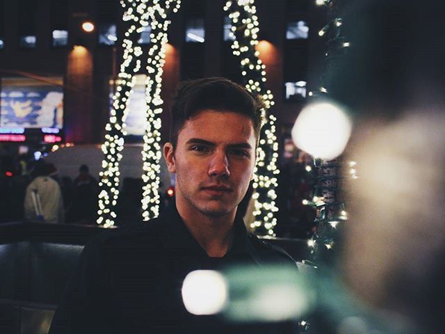 illuminated, night, indoors, portrait, looking at camera, lifestyles, lighting equipment, front view, headshot, focus on foreground, celebration, leisure activity, person, young adult, close-up, reflection, christmas tree, light - natural phenomenon