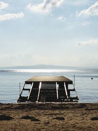 Lifeguard hut on beach against sky