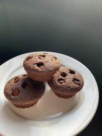 Close-up of cookies in plate against black background