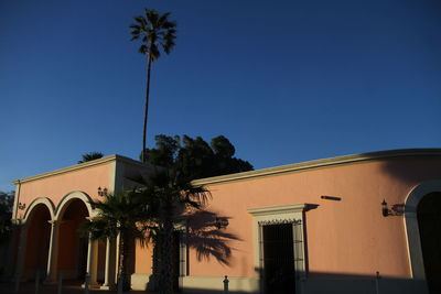 Low angle view of building against clear blue sky