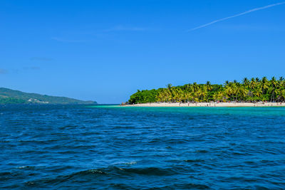 Scenic view of sea against blue sky