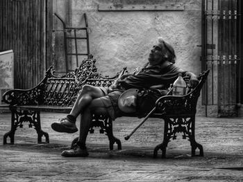 Woman sitting on chair outdoors