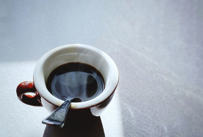 Close-up of hand holding black coffee