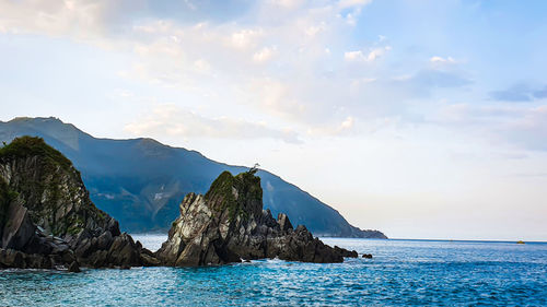 Panoramic view of sea and mountains against sky