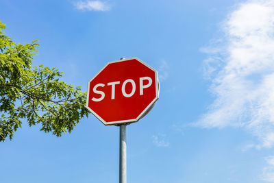 A traffic stop sign on the blue sky background