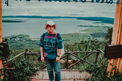 Portrait of boy standing on railing