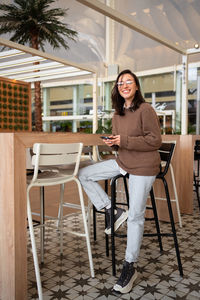 Young woman sitting on chair