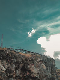 Rock formations by sea against sky