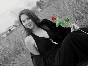 Portrait of beautiful woman with red flowers