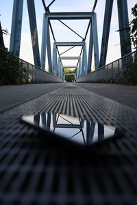 Reflection of footbridge against sky