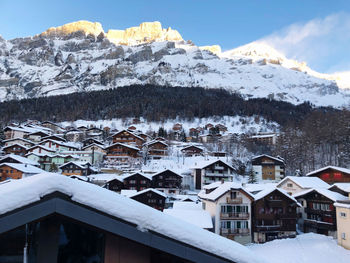 Snow covered houses against mountain