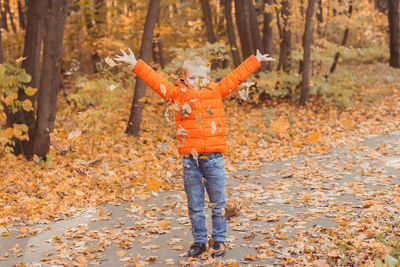 Full length of a boy with arms raised