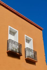 Low angle view of building against clear blue sky