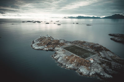 Soccer field on the cliffs of henningsvær by the sea