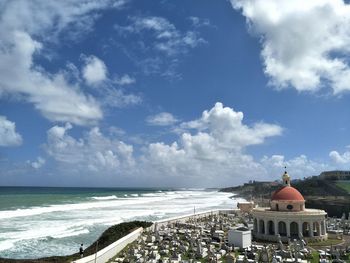 Panoramic view of sea and buildings against sky