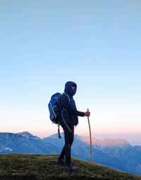 Man standing on mountain against clear sky