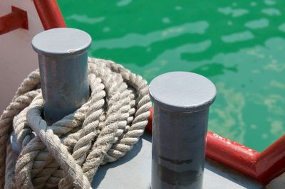 Close up picture of two bollards with mooring rope of a tourism boat on the lake lugano, switzerland