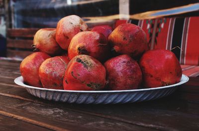 Close-up of apples in container on table