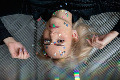 High angle portrait of girl lying on floor