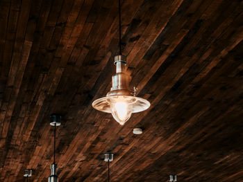 Low angle view of rustic ceiling with lighting fixture