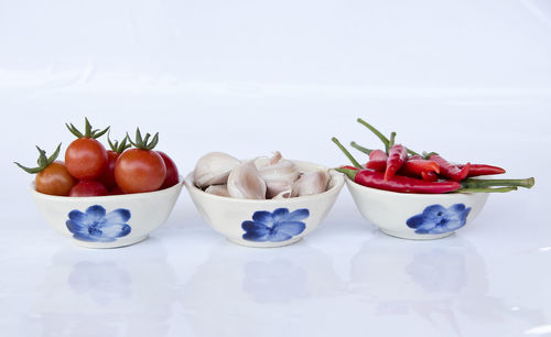 Close-up of red fruit over white background