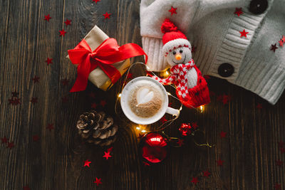 Christmas cup of coffee with sweater and christmas decorations.