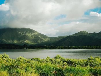 Scenic view of lake and mountains against sky