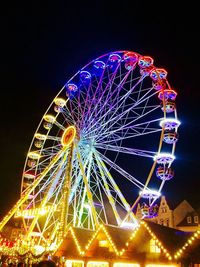 Low angle view of ferris wheel at night