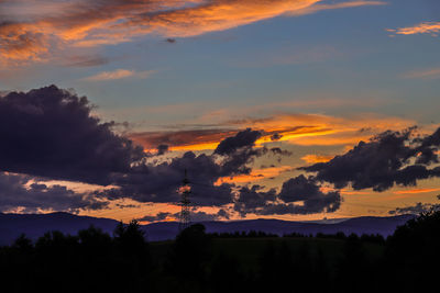 Silhouette trees against sky during sunset