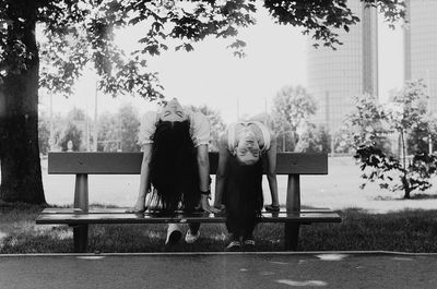 Women sitting on bench while sitting at park