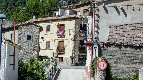 Road sign against buildings in city