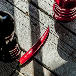 High angle view of red chili peppers on wooden table