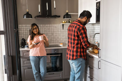 Side view of young woman working at home