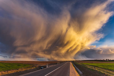 Road by landscape against sky