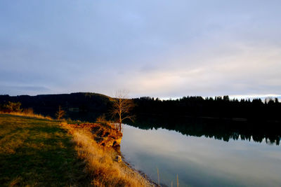 Scenic view of lake against sky during sunset