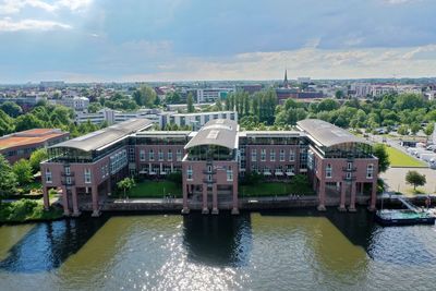 High angle view of river by buildings against sky