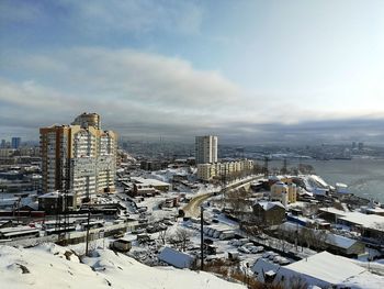 High angle view of buildings in city against sky