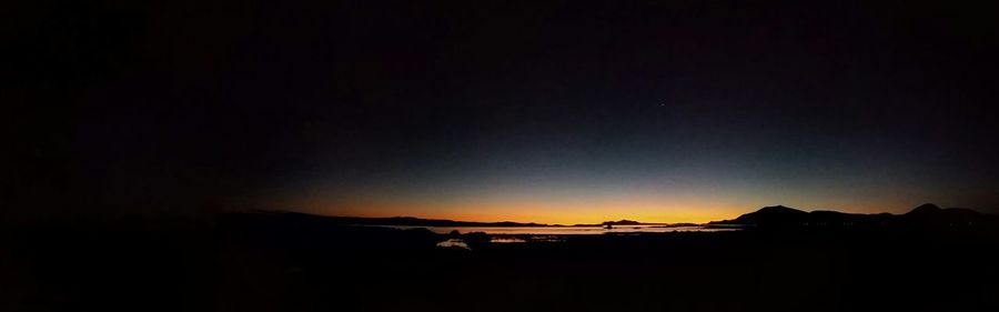 Scenic view of mountains against sky at sunset